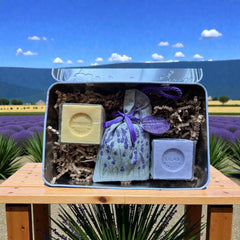 French holiday tin gift box with two mini Marseille soaps and a lavender sachet nestled in crinkle paper, available in Paris, Nice, or Côte d’Azur designs — a festive surprise gift from France.