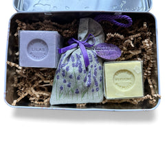 French holiday tin gift box with two mini Marseille soaps and a lavender sachet nestled in crinkle paper, available in Paris, Nice, or Côte d’Azur designs — a festive surprise gift from France.