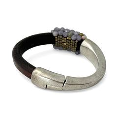Brown leather and silver-tone half cuff bracelet with magnetic clasp, hand-stitched faceted purple and green amethyst beads, featuring a signature gold accent bead; size 6.