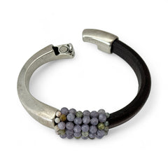 Brown leather and silver-tone half cuff bracelet with magnetic clasp, hand-stitched faceted purple and green amethyst beads, featuring a signature gold accent bead; size 6.