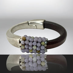 Brown leather and silver-tone half cuff bracelet with magnetic clasp, hand-stitched faceted purple and green amethyst beads, featuring a signature gold accent bead; size 6.
