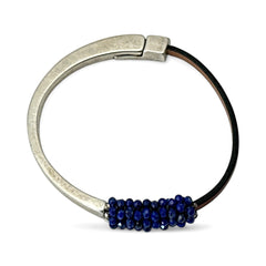 Artisan bracelet featuring a silver-tone half cuff and brown leather band, hand-stitched with faceted lapis beads and a signature gold accent; Martell Studio design, size 6 with magnetic clasp.