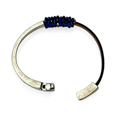 Artisan bracelet featuring a silver-tone half cuff and brown leather band, hand-stitched with faceted lapis beads and a signature gold accent; Martell Studio design, size 6 with magnetic clasp.