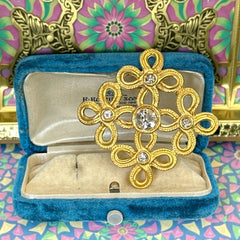 Vintage matte gold tone brooch with textured open loops and clear rhinestones, shown from different angles to highlight its square or diamond shape and detailed craftsmanship