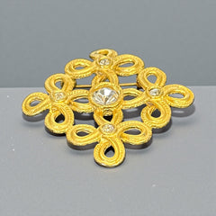 Vintage matte gold tone brooch with textured open loops and clear rhinestones, shown from different angles to highlight its square or diamond shape and detailed craftsmanship