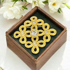 Vintage matte gold tone brooch with textured open loops and clear rhinestones, shown from different angles to highlight its square or diamond shape and detailed craftsmanship