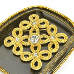 Vintage matte gold tone brooch with textured open loops and clear rhinestones, shown from different angles to highlight its square or diamond shape and detailed craftsmanship