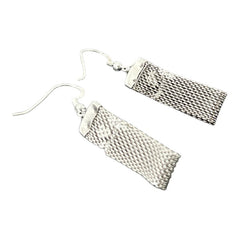 Vintage clear rhinestone and silver tone mesh dangle earrings with emerald-cut rhinestones and chaton accents, paired with sterling silver ear wires, photographed against a clean, neutral backdrop.