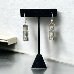 Vintage clear rhinestone and silver tone mesh dangle earrings with emerald-cut rhinestones and chaton accents, paired with sterling silver ear wires, photographed against a clean, neutral backdrop.