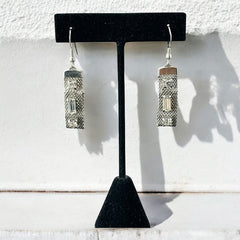 Vintage clear rhinestone and silver tone mesh dangle earrings with emerald-cut rhinestones and chaton accents, paired with sterling silver ear wires, photographed against a clean, neutral backdrop.