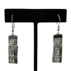 Vintage clear rhinestone and silver tone mesh dangle earrings with emerald-cut rhinestones and chaton accents, paired with sterling silver ear wires, photographed against a clean, neutral backdrop.