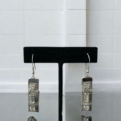 Vintage clear rhinestone and silver tone mesh dangle earrings with emerald-cut rhinestones and chaton accents, paired with sterling silver ear wires, photographed against a clean, neutral backdrop.