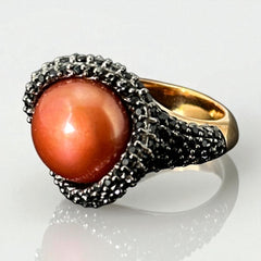 Vintage Honora Italy bronze ring featuring a 12.5mm orange cultured pearl surrounded by faceted black spinel; warm-toned statement jewelry with autumnal elegance and sculptural detail.