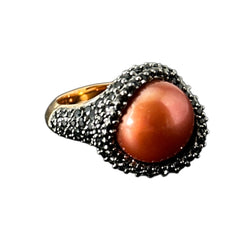 Vintage Honora Italy bronze ring featuring a 12.5mm orange cultured pearl surrounded by faceted black spinel; warm-toned statement jewelry with autumnal elegance and sculptural detail.