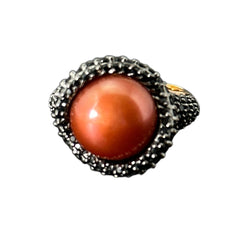 Vintage Honora Italy bronze ring featuring a 12.5mm orange cultured pearl surrounded by faceted black spinel; warm-toned statement jewelry with autumnal elegance and sculptural detail.