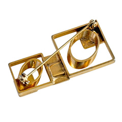 Vintage geometric modernist brooch with red, black, and white enamel in gold‑tone metal.