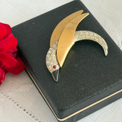 Vintage modernist bird brooch in gold and silver tone with pavé rhinestones and black enamel details.