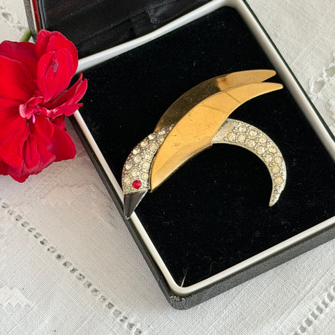 Vintage modernist bird brooch in gold and silver tone with pavé rhinestones and black enamel details.