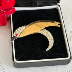 Vintage modernist bird brooch in gold and silver tone with pavé rhinestones and black enamel details.