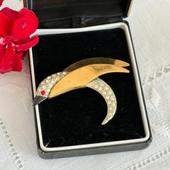 Vintage modernist bird brooch in gold and silver tone with pavé rhinestones and black enamel details.