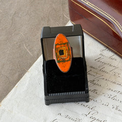 Vintage Brazilian copper ring with orange, green, and gold enamel geometric oval design, adjustable band, signed Artesanato Moida Bitter Belo Horizonte Brazil.