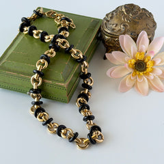 Vintage Monet gold‑tone chain link necklace with black accents, shown in various angles to highlight its adjustable length and signed hangtag.