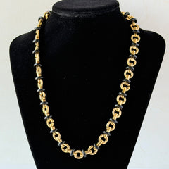 Vintage Monet gold‑tone chain link necklace with black accents, shown in various angles to highlight its adjustable length and signed hangtag.