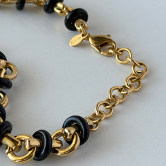 Vintage Monet gold‑tone chain link necklace with black accents, shown in various angles to highlight its adjustable length and signed hangtag.