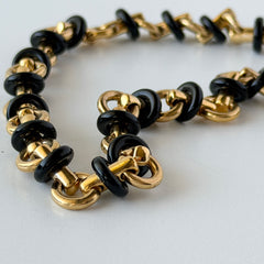 Vintage Monet gold‑tone chain link necklace with black accents, shown in various angles to highlight its adjustable length and signed hangtag.
