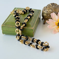 Vintage Monet gold‑tone chain link necklace with black accents, shown in various angles to highlight its adjustable length and signed hangtag.