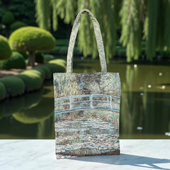 Tapestry tote bag featuring Monet’s Japanese Bridge and Water Lilies, woven in France with soft green, blue, and pink tones; double-sided print with long handles, inspired by Impressionist art.