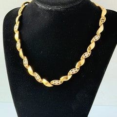 Vintage Monet gold‑tone marquise link necklace with alternating polished and openwork rhinestone links, shown in various angles to highlight its bright finish, signed clasp, and 16½‑inch length.