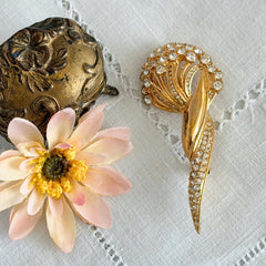 Vintage Monet gold tone brooch with pave rhinestones in a stylized floral umbel design.
