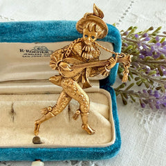 Vintage Monet gold tone minstrel brooch with blue rhinestones, 1960s signed © Monet figural jester