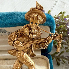 Vintage Monet gold tone minstrel brooch with blue rhinestones, 1960s signed © Monet figural jester
