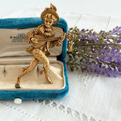 Vintage Monet gold tone minstrel brooch with blue rhinestones, 1960s signed © Monet figural jester