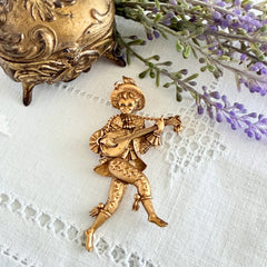 Vintage Monet gold tone minstrel brooch with blue rhinestones, 1960s signed © Monet figural jester