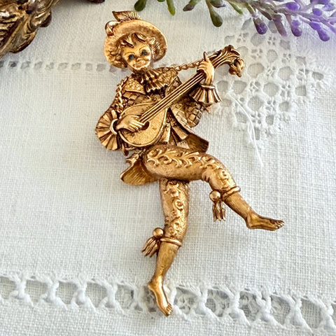 Vintage Monet gold tone minstrel brooch with blue rhinestones, 1960s signed © Monet figural jester