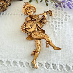 Vintage Monet gold tone minstrel brooch with blue rhinestones, 1960s signed © Monet figural jester