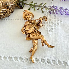 Vintage Monet gold tone minstrel brooch with blue rhinestones, 1960s signed © Monet figural jester