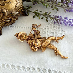 Vintage Monet gold tone minstrel brooch with blue rhinestones, 1960s signed © Monet figural jester