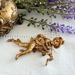 Vintage Monet gold tone minstrel brooch with blue rhinestones, 1960s signed © Monet figural jester