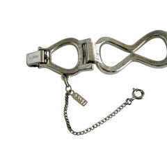 Vintage Monet silver‑tone infinity link bracelet with polished modernist links and signed clasp.