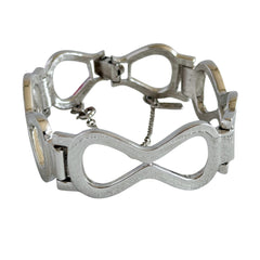 Vintage Monet silver‑tone infinity link bracelet with polished modernist links and signed clasp.