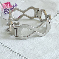 Vintage Monet silver‑tone infinity link bracelet with polished modernist links and signed clasp.