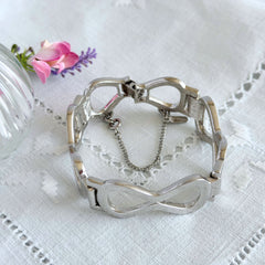 Vintage Monet silver‑tone infinity link bracelet with polished modernist links and signed clasp.