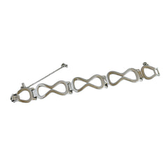 Vintage Monet silver‑tone infinity link bracelet with polished modernist links and signed clasp.