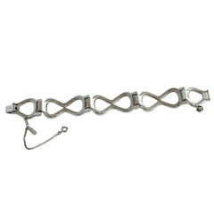 Vintage Monet silver‑tone infinity link bracelet with polished modernist links and signed clasp.