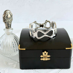 Vintage Monet silver‑tone infinity link bracelet with polished modernist links and signed clasp.
