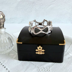 Vintage Monet silver‑tone infinity link bracelet with polished modernist links and signed clasp.